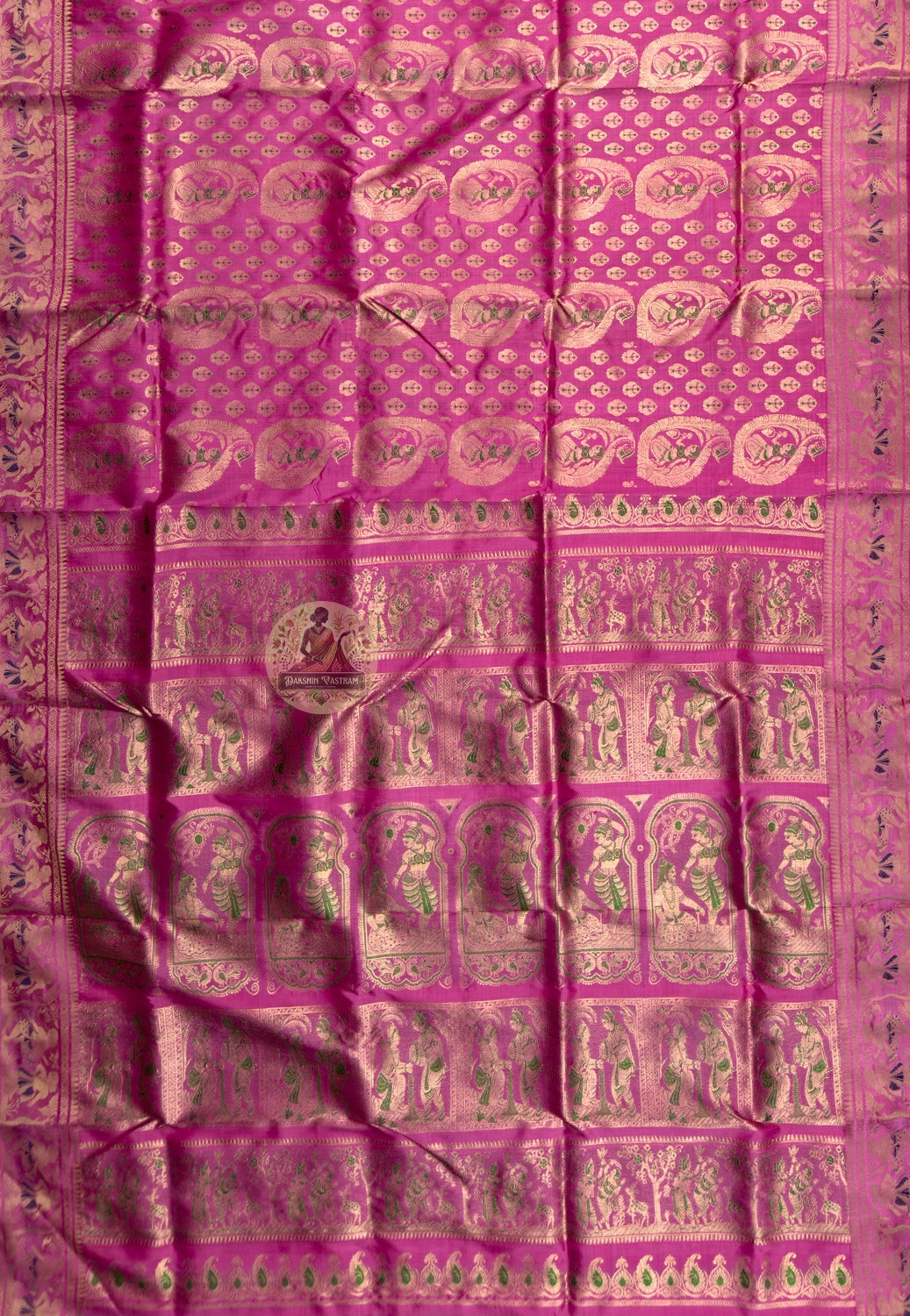 Rear view of premium Swarnachari silk saree displaying golden zari pallu with hand-woven Bengal temple and Ramayana story compositions held in readiness, complete in craft and waiting in meaning
