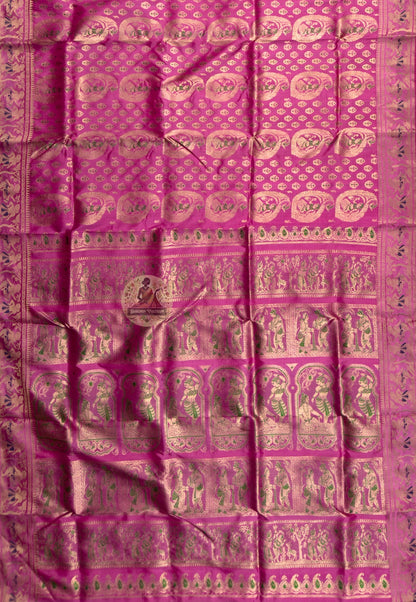 Rear view of premium Swarnachari silk saree displaying golden zari pallu with hand-woven Bengal temple and Ramayana story compositions held in readiness, complete in craft and waiting in meaning
