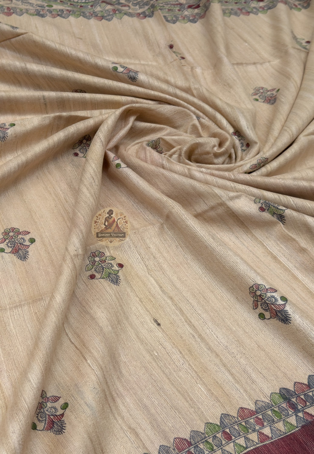 Close up of small dark-toned motifs across the beige Ghicha Tussar silk saree body