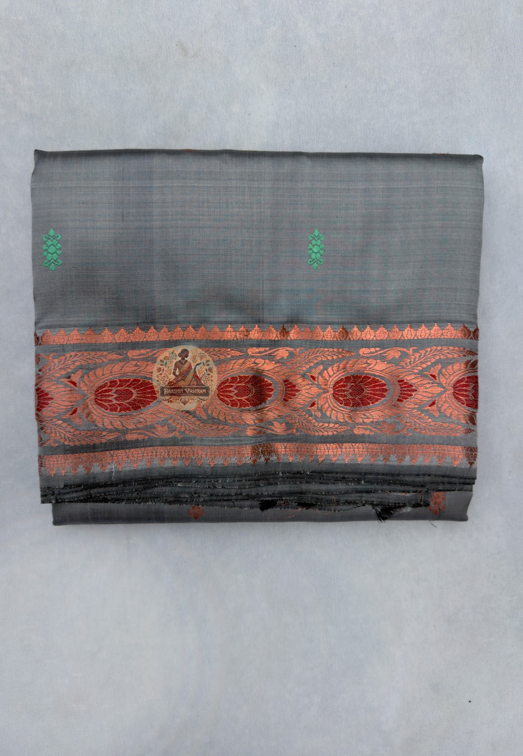 Close-up of premium Swarnachari silk saree pallu showing hand-woven golden zari language panel with Bengal royal court figures and temple tradition sentences stated with the precision of a fluent weaver
