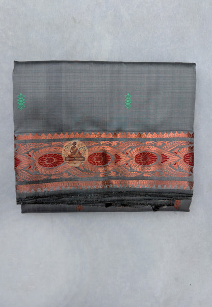 Close-up of premium Swarnachari silk saree pallu showing hand-woven golden zari language panel with Bengal royal court figures and temple tradition sentences stated with the precision of a fluent weaver