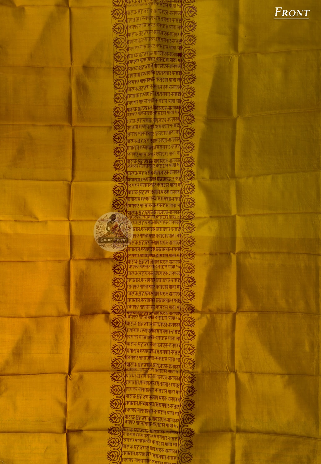 Flat lay of unstitched Baluchari Silk Kurti Piece showing swirling kalka repeat and dotted wave border full fabric length