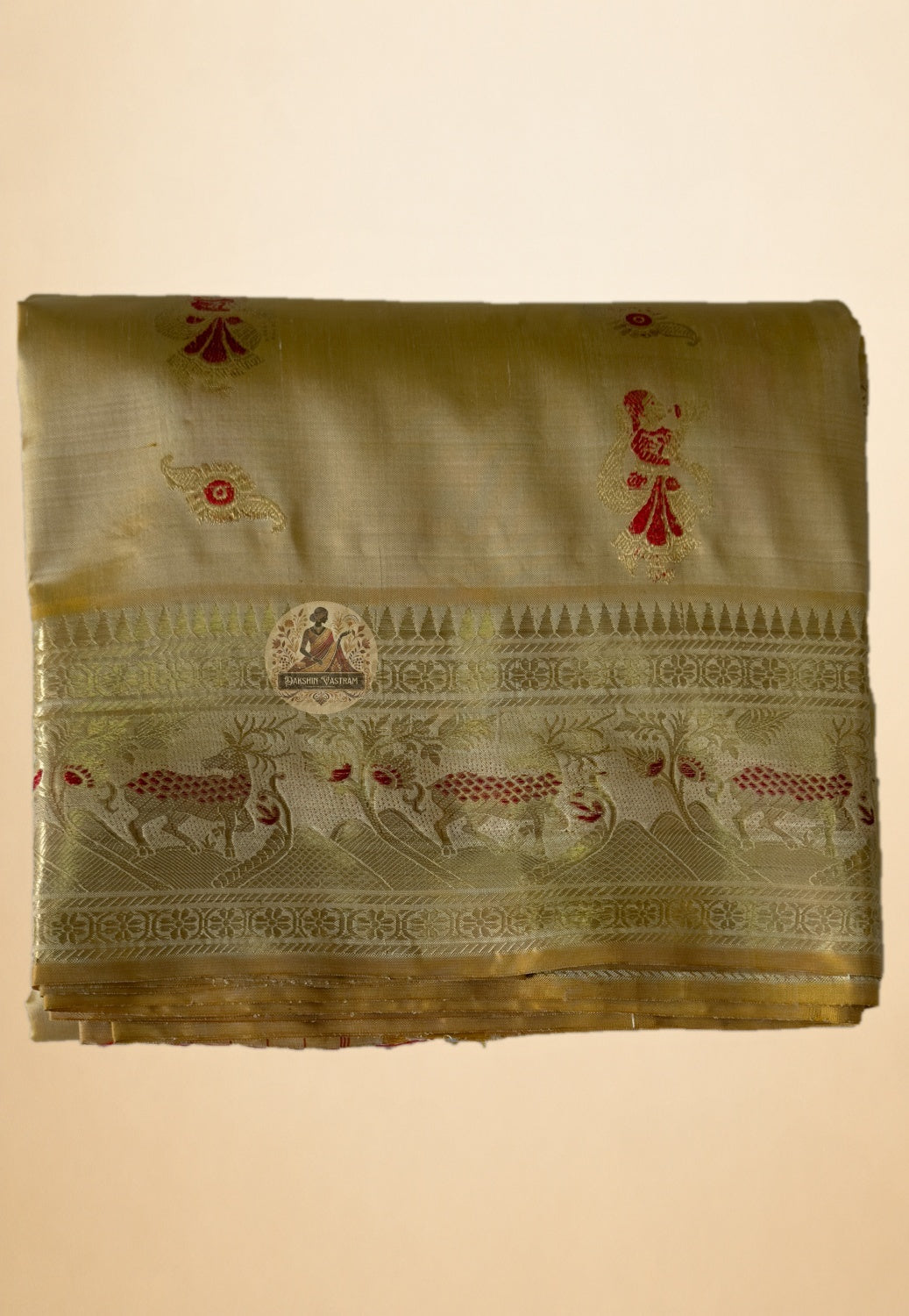 Full saree view highlighting beige gold pleats, patterned borders and red-accented figurative panels