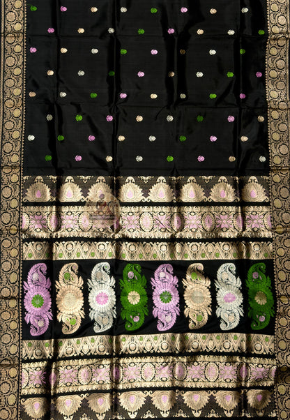 Close-up of premium Swarnachari silk saree pallu showing hand-woven golden zari panel with Bengal royal court figures and temple tradition compositions poised at the threshold between craft and occasion