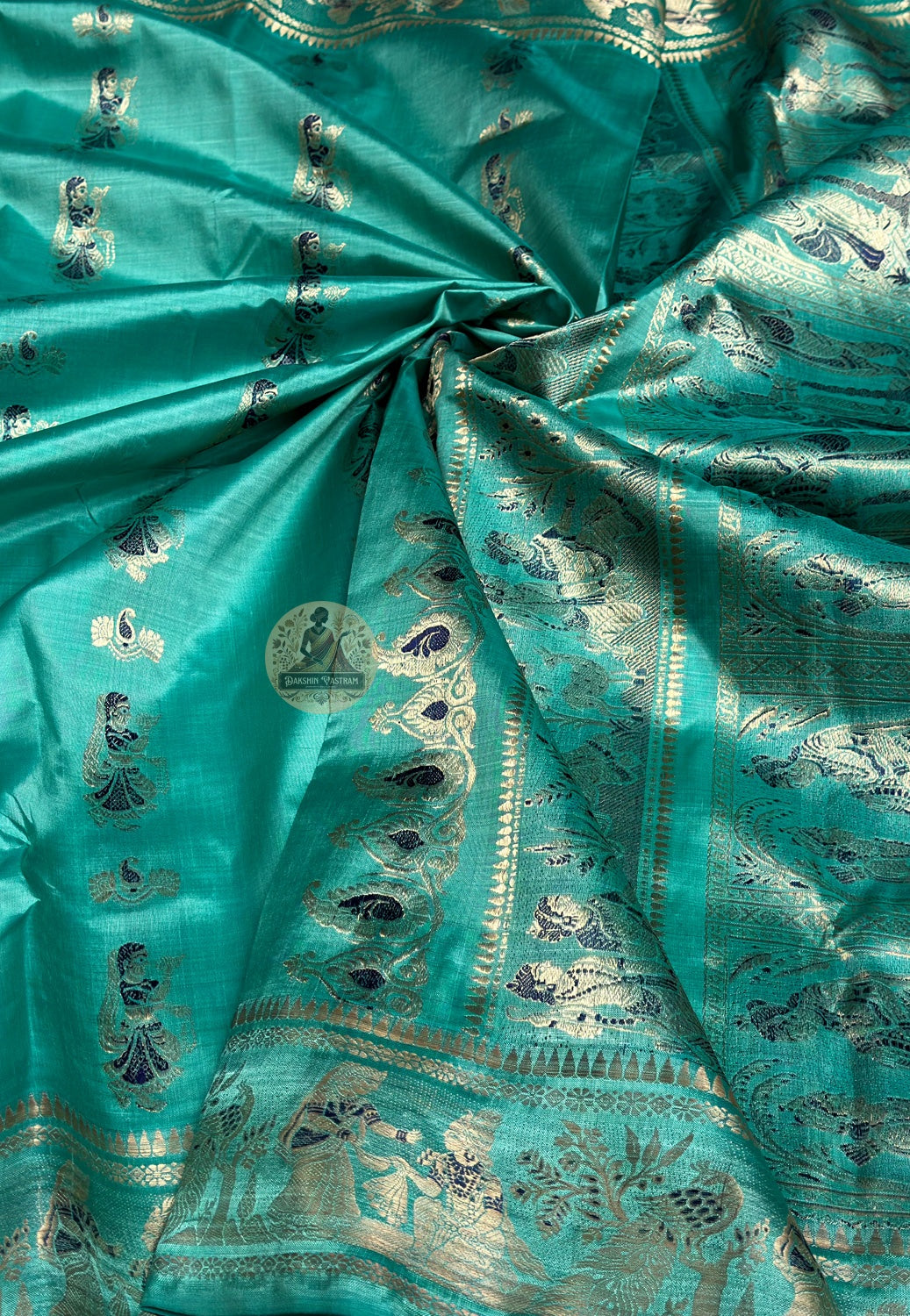 Close-up of golden zari Shakuntala letter to Dushyanta border detail on teal green Swarnachari Silk Saree Bishnupur Bengal handloom