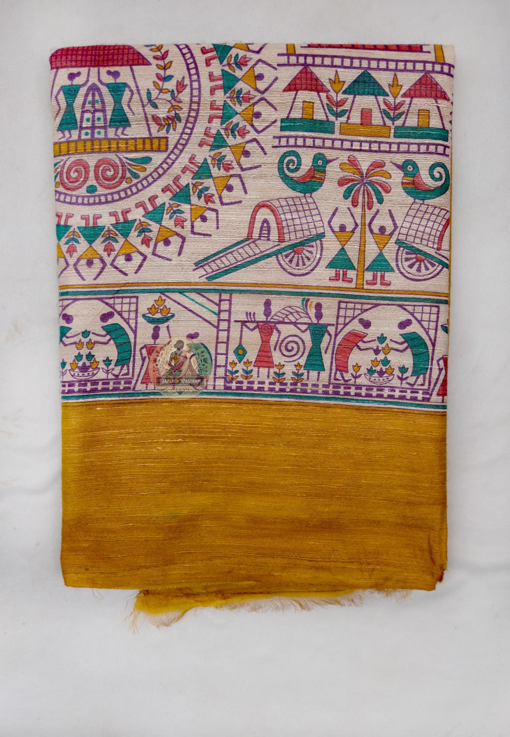 Full saree view highlighting mustard-gold pleats, broad decorative borders and pale multicoloured pallu panels