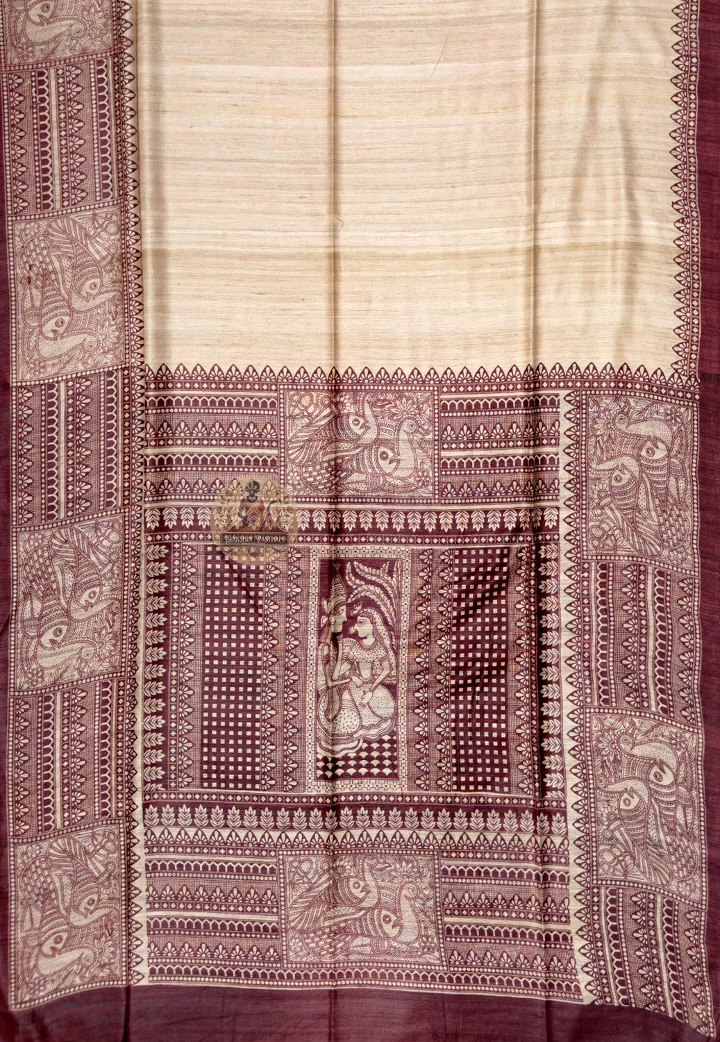 Close up of maroon saree border with pale ornamental panels and pointed motifs