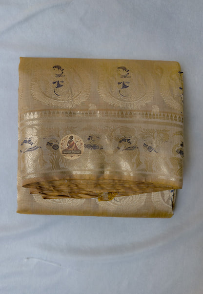 Full flat-lay of premium Swarnachari pure silk saree with devotion-grade golden zari border, unified narrative pallu, precisely spaced buti field, and matching unstitched blouse piece, West Bengal handloom