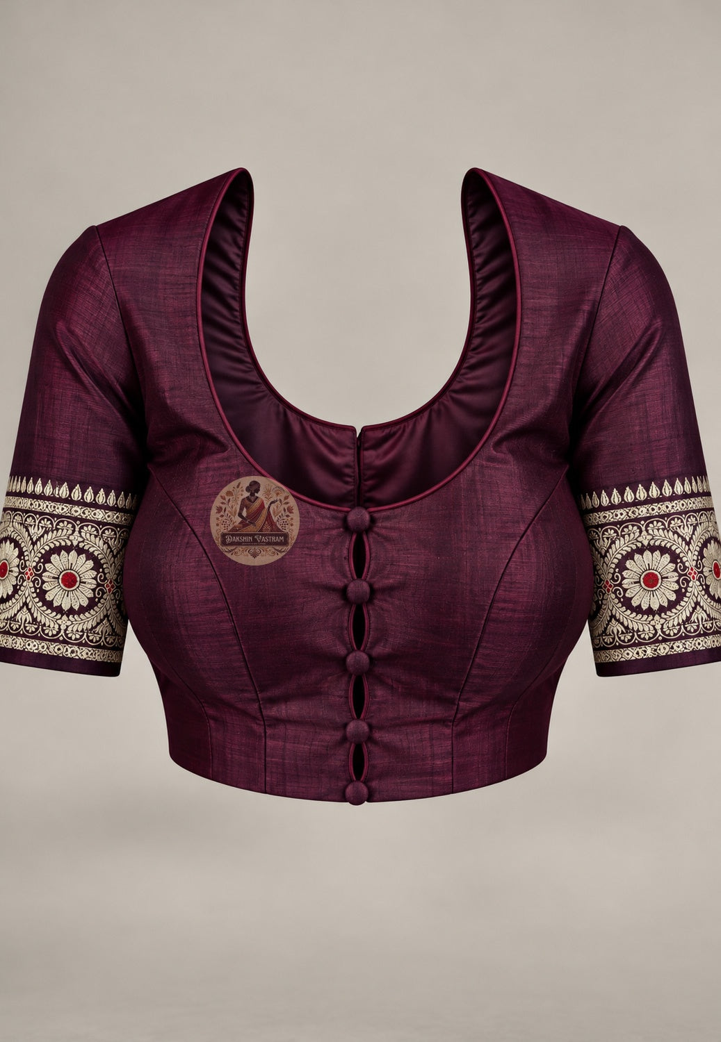 Blouse in matching wine paired with the Baluchari silk saree, featuring pale patterned sleeve borders