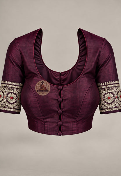 Blouse in matching wine paired with the Baluchari silk saree, featuring pale patterned sleeve borders