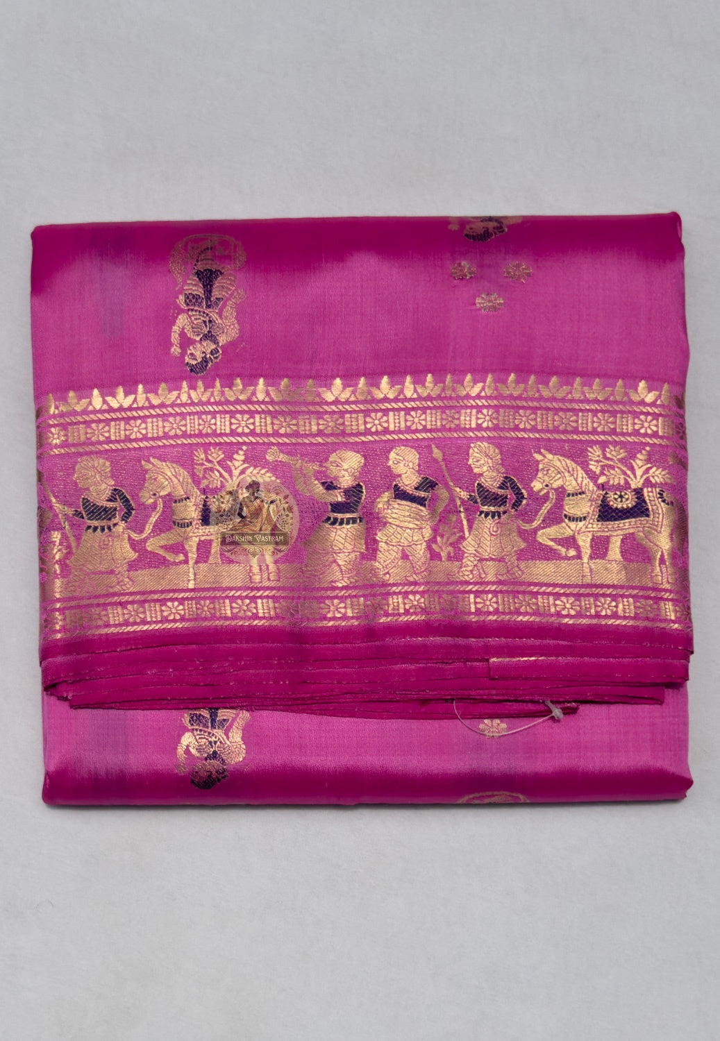 Close-up of Swarnachari handloom silk saree body showing natural silk texture with hand-thrown shuttle irregularity and fine golden zari butis (small woven motifs)