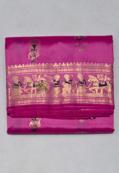 Close-up of Swarnachari handloom silk saree body showing natural silk texture with hand-thrown shuttle irregularity and fine golden zari butis (small woven motifs)