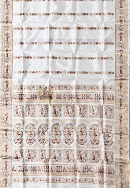 Close-up of pallu of white Swarnachari pure silk saree showing golden zari mythology and Bishnupur temple art compositions reading with precision and clarity on white silk ground