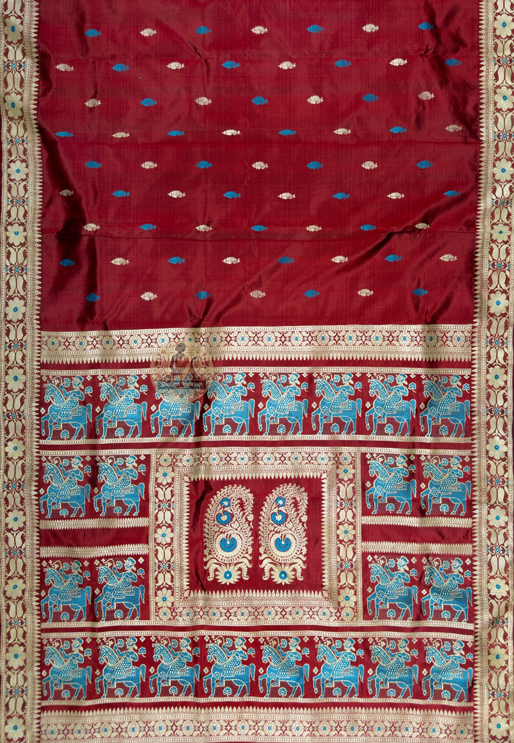 Close up of maroon Baluchari silk saree pallu with blue horses and riders surrounding paired paisley motifs