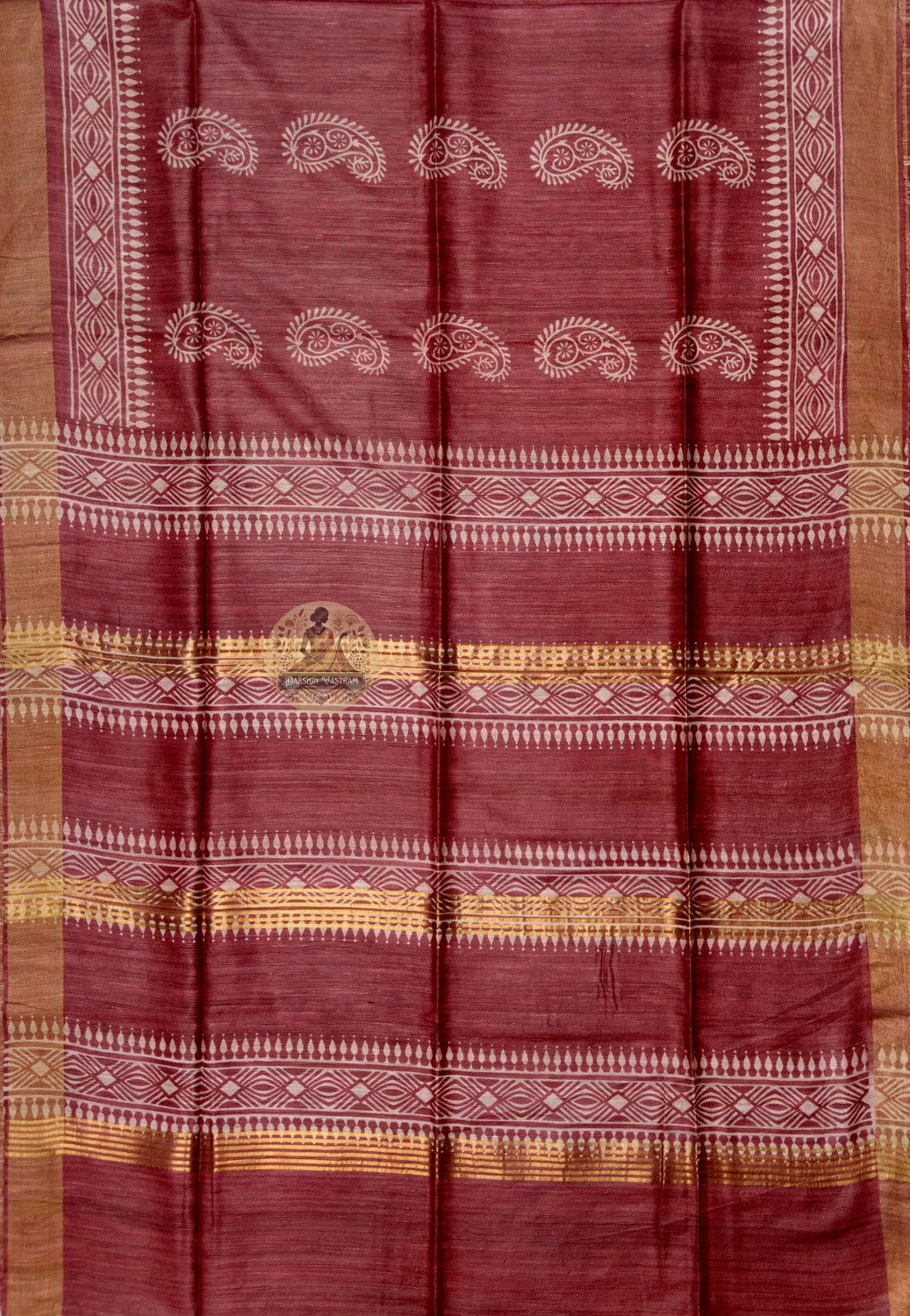 Full saree view of deep red Ghicha Tussar silk saree with paisley motifs and broad gold-toned edges