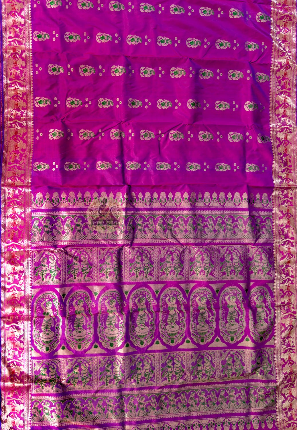 Side view of purple Swarnachari pure silk saree displaying natural fluid drape and golden zari brightening against deep purple silk in the amber light of Durga Puja Sandhi Puja evening