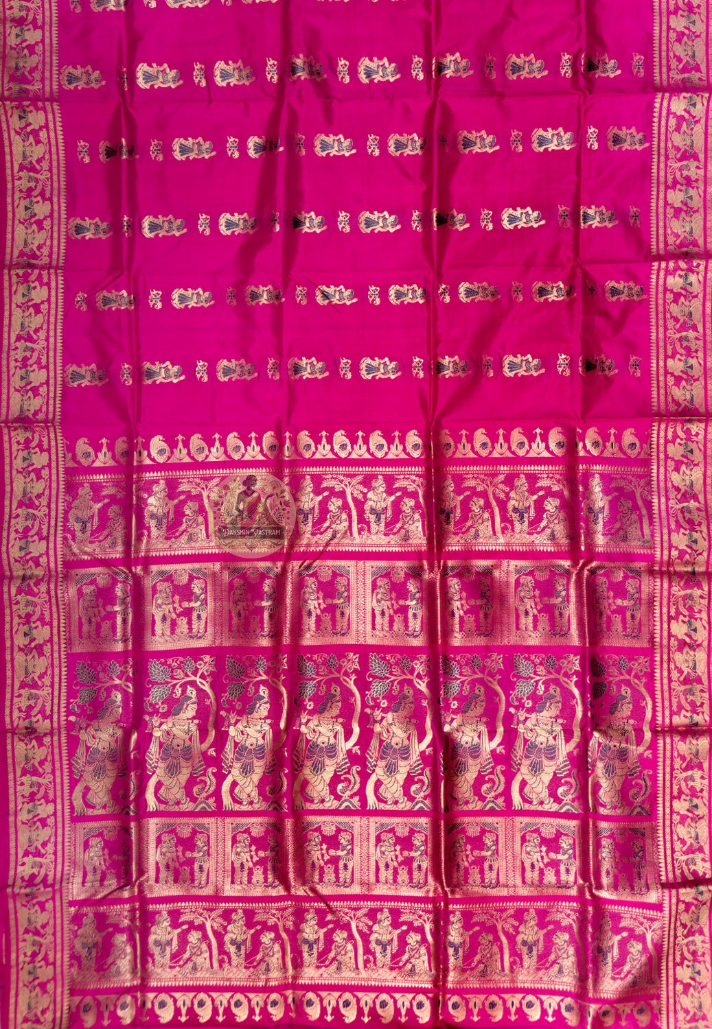 Full saree view of rani pink Swarnachari silk saree with small body motifs and an elaborate pallu