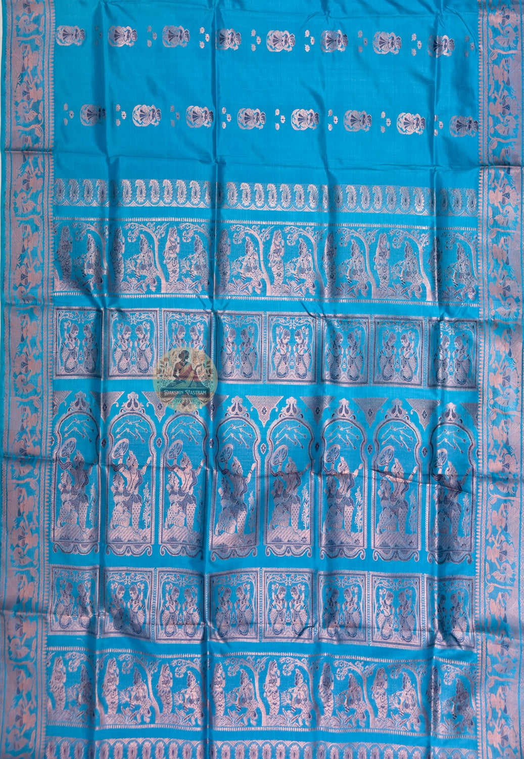 Full saree view of teal blue Swarnachari silk saree with repeating motifs and an elaborate pallu