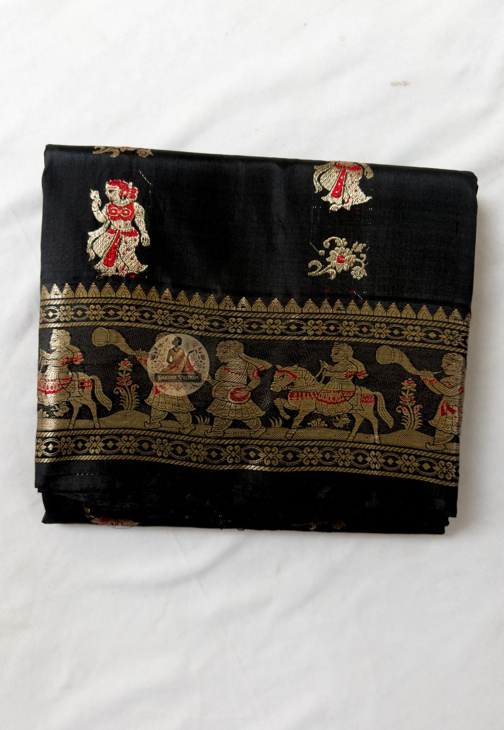 Close-up of purple Swarnachari silk saree weave showing golden zari Malla court figures mythology motifs and Bishnupur temple art patterns warming against deep purple silk ground