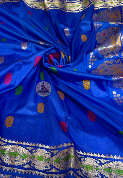 Close-up of premium Swarnachari silk saree pallu showing precisely rendered hand-woven golden zari portrait panel with Bengal mythological figures and temple-art scene stated with full clarity