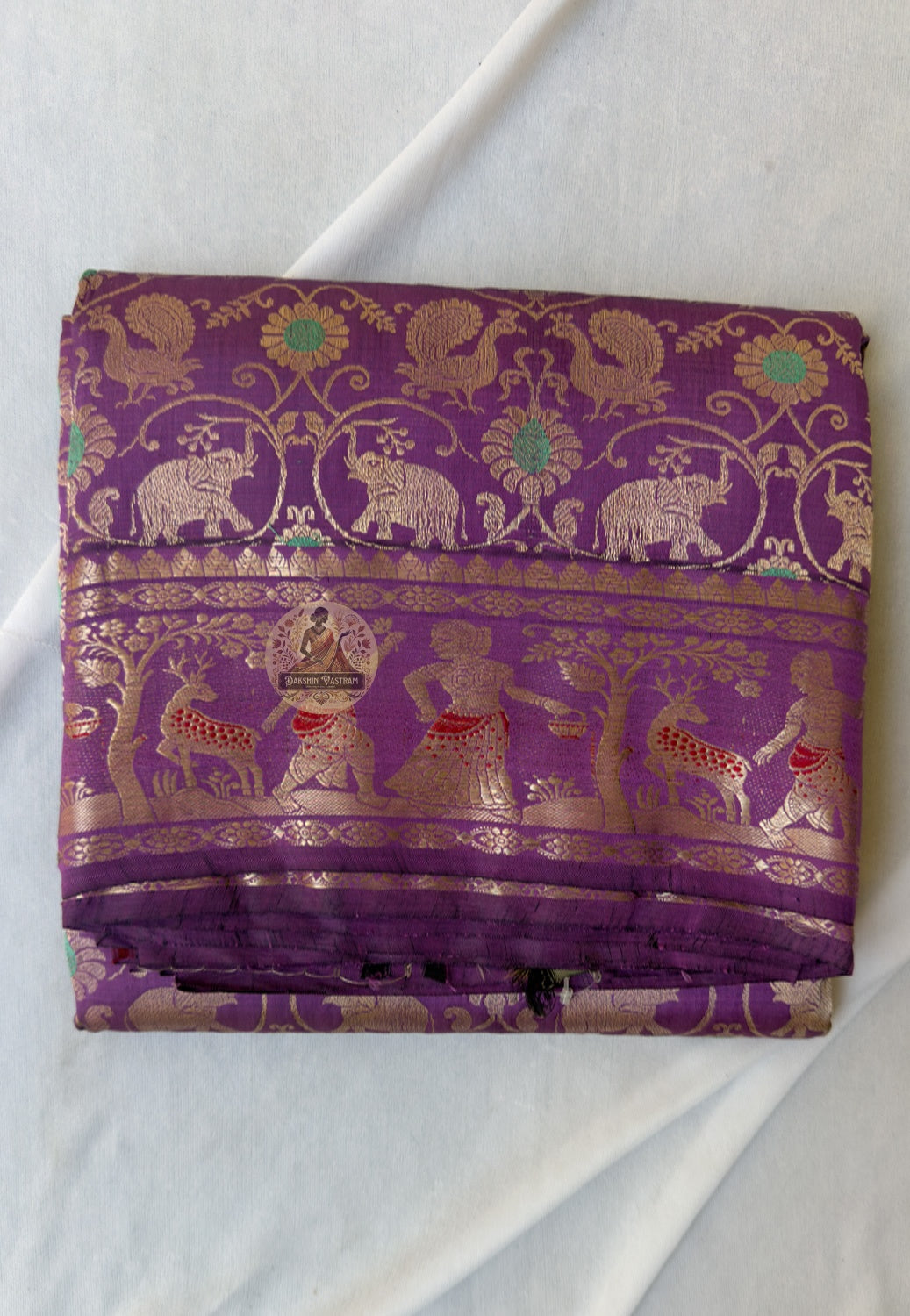 Rear view of premium Swarnachari silk saree displaying golden zari pallu with hand-woven unified narrative composition of Bengal temple and Ramayana-inspired scenes