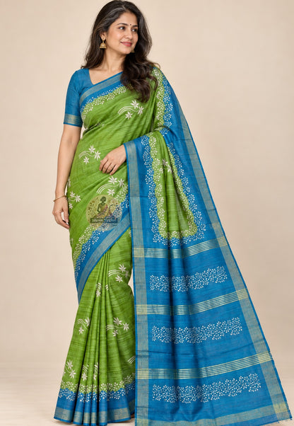 Side view of green Ghicha Tussar silk saree showing the pleated drape and blue border with gold-toned edging