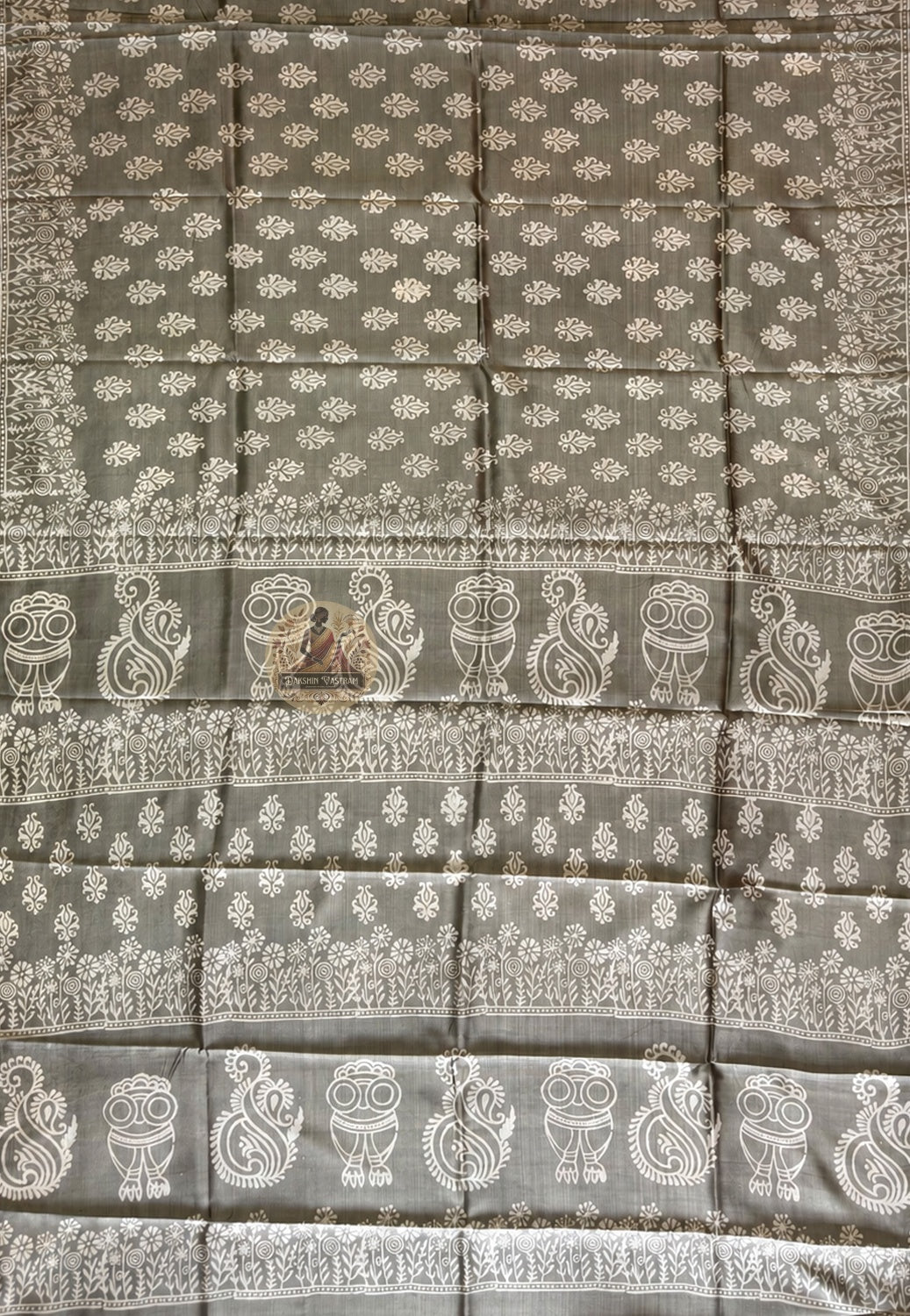 Close-up of Bishnupur Katan silk saree pallu showing hand block print composition with terracotta-inspired floral and figurative motifs pressed into pure silk using carved wooden blocks, Bishnupur West Bengal