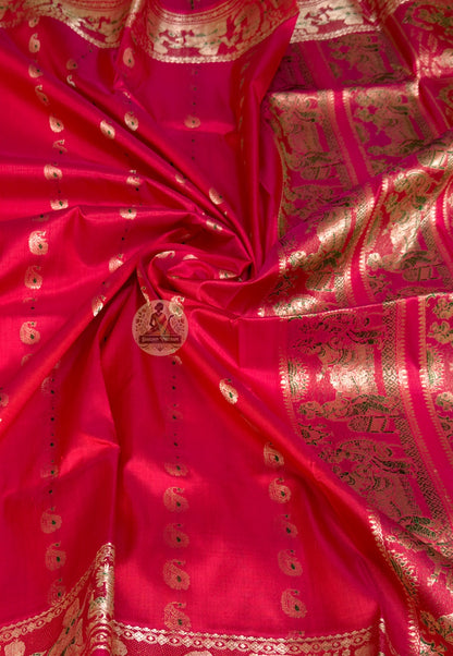 Close-up of Swarnachari silk saree pallu showing hand-woven golden zari panel with Bengal royal court figures and temple tradition stories poised for the occasion that will bring them to life