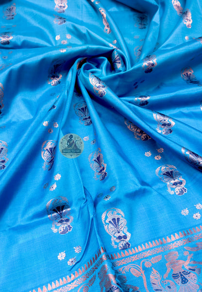 Close up of teal blue Swarnachari silk saree pallu with figurative panels and arch-shaped frames