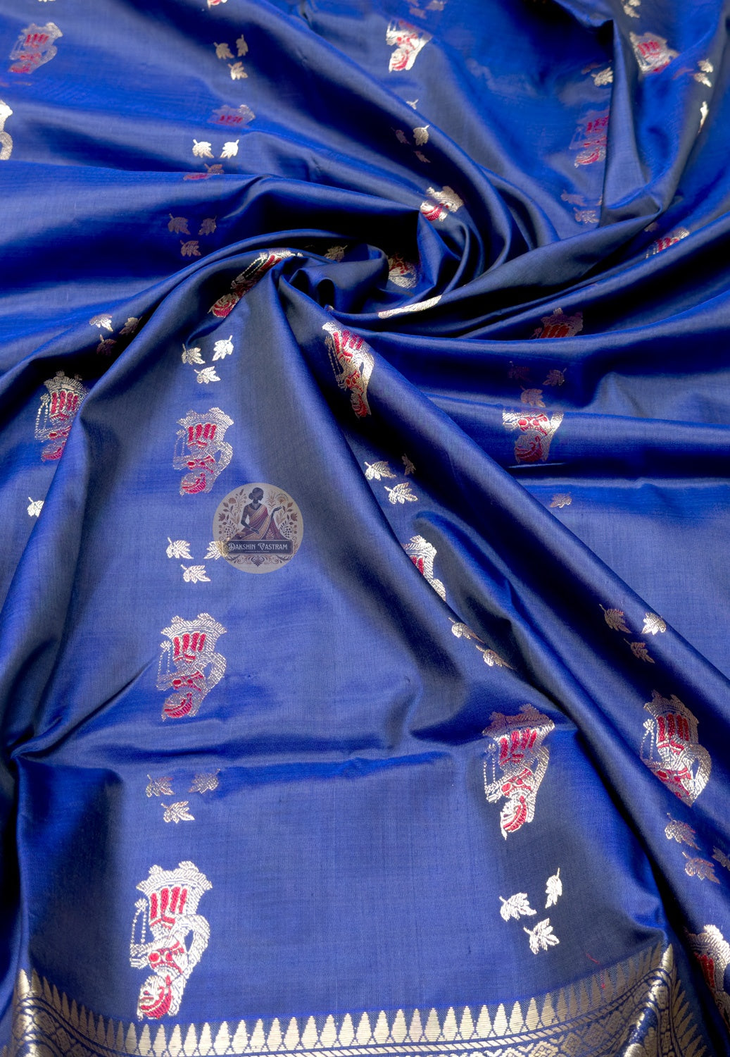 Close up of royal blue Swarnachari silk saree pallu with figurative rows and large oval panels