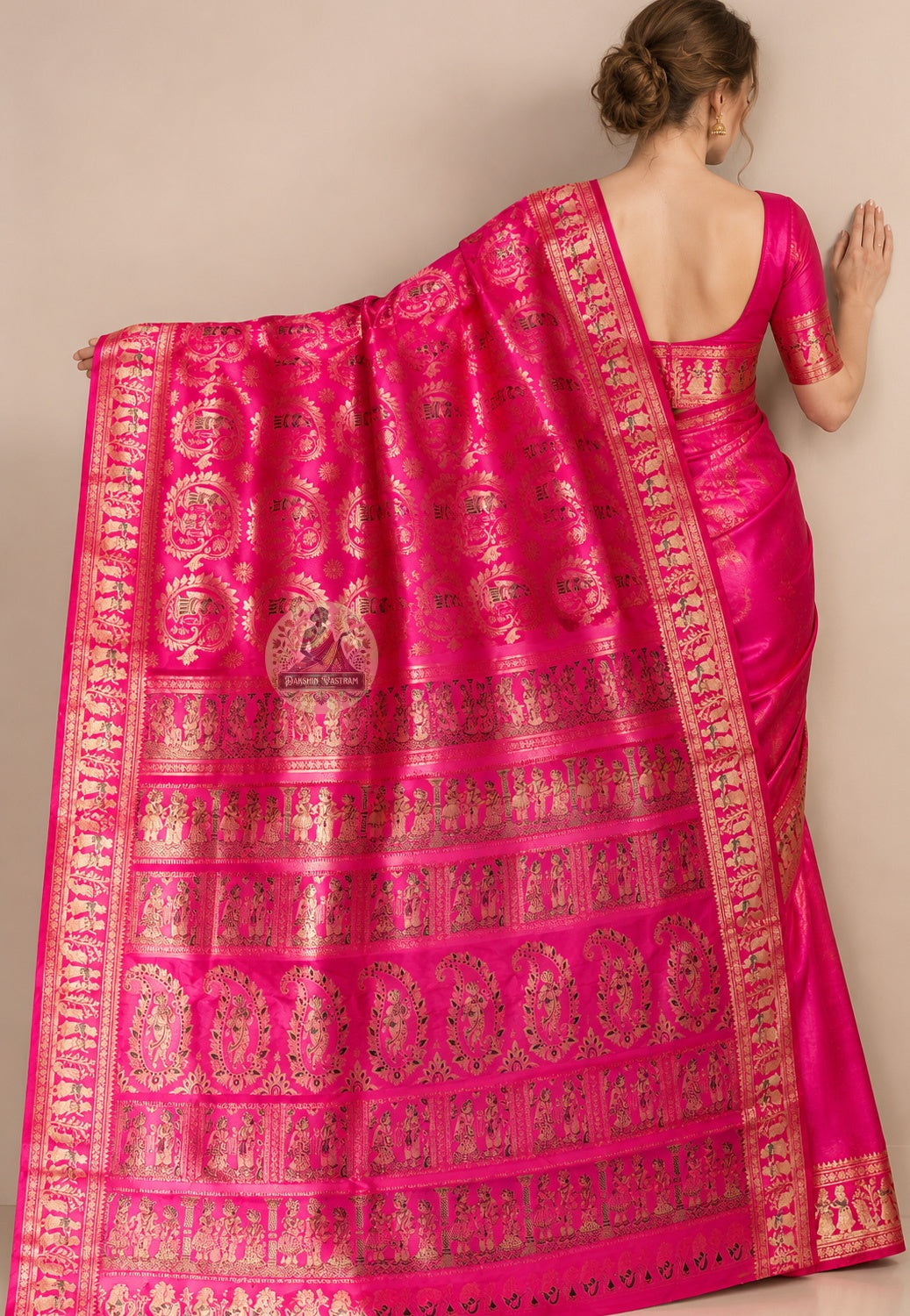 Side view of pink Swarnachari pure silk saree displaying natural fluid drape and golden zari warmth deepening against festive pink silk ground for wedding receptions and Diwali celebrations