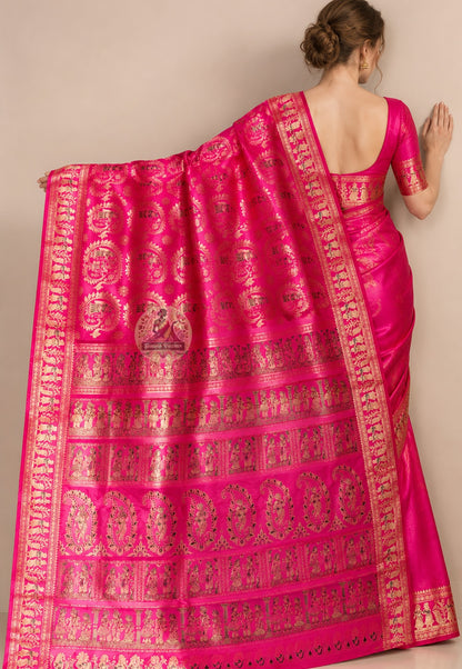 Side view of pink Swarnachari pure silk saree displaying natural fluid drape and golden zari warmth deepening against festive pink silk ground for wedding receptions and Diwali celebrations