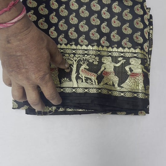 Full saree view highlighting black pleats and warm gold-toned storytelling panels on the pallu