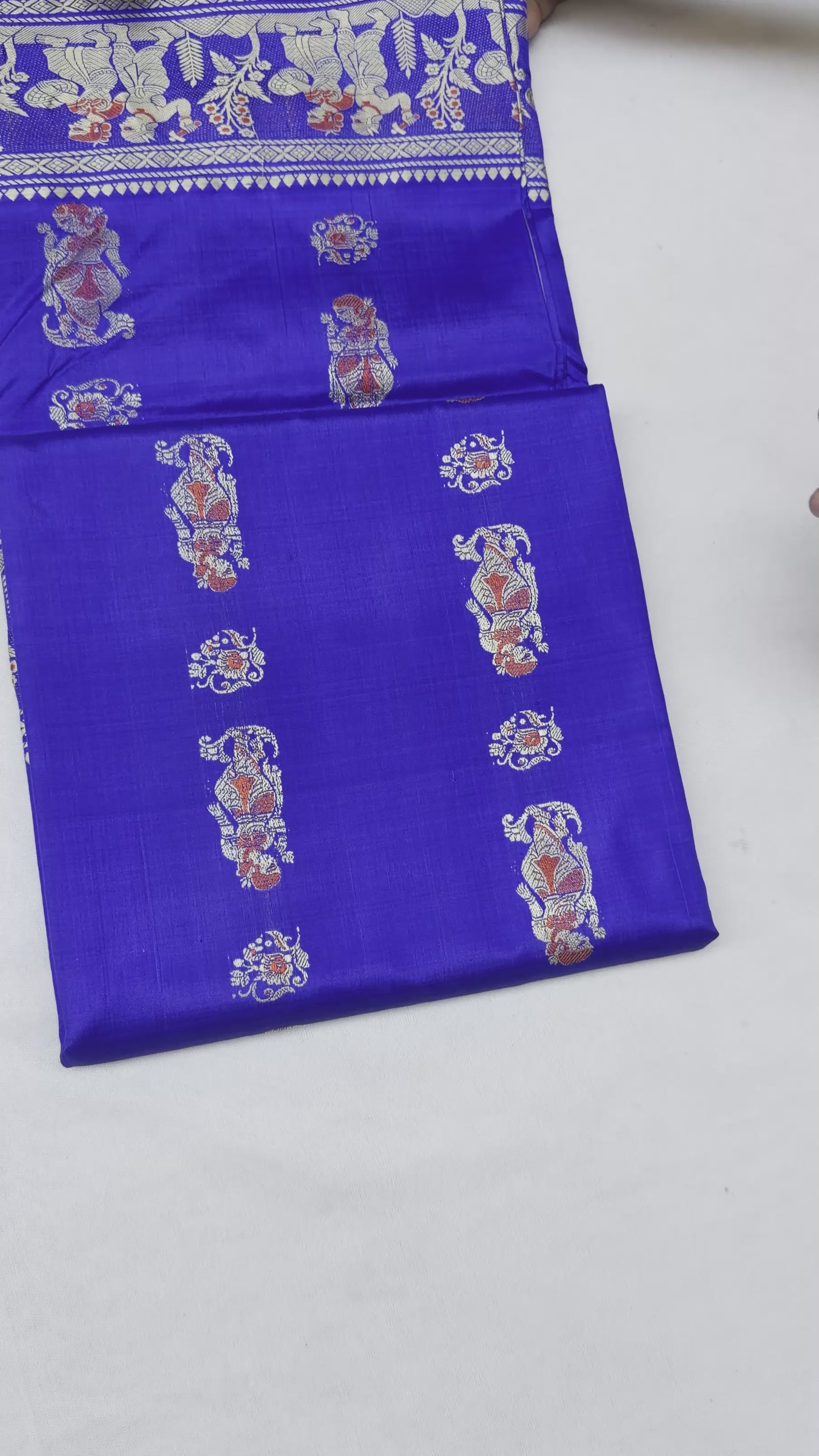 Full saree view highlighting royal blue pleats, decorative borders and the figurative paisley pallu⠋