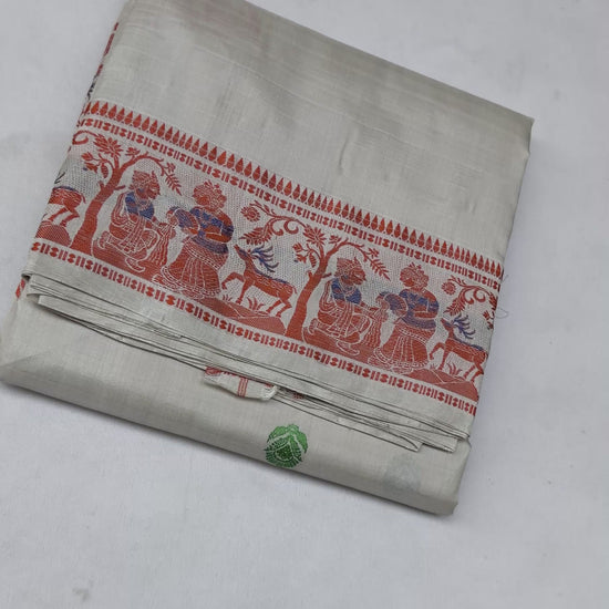 Full saree view highlighting the cream silk drape, red patterned border and multicoloured pallu