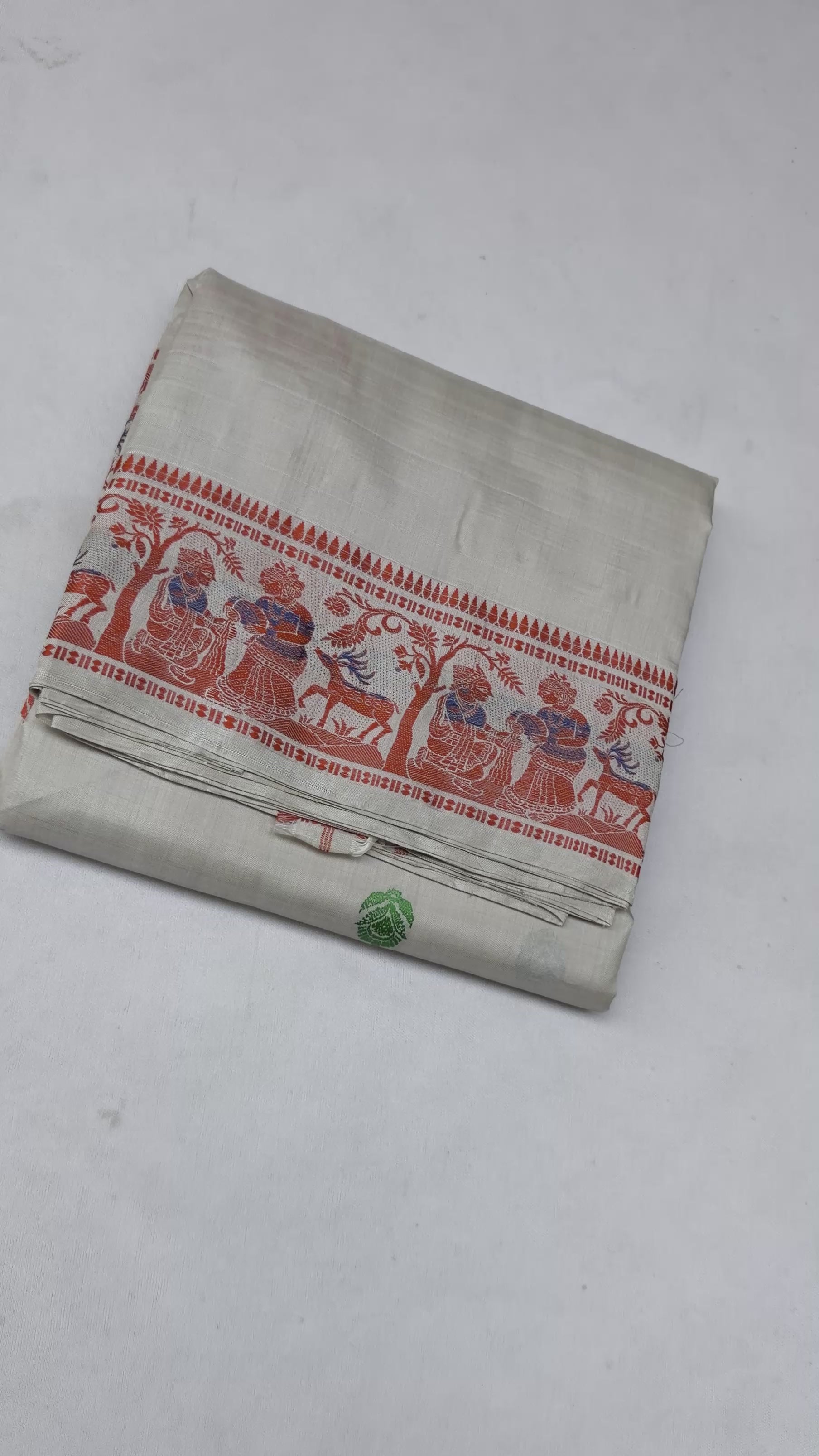 Full saree view highlighting the cream silk drape, red patterned border and multicoloured pallu