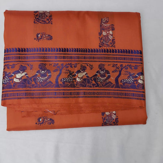 Full saree view highlighting orange pleats and the elaborate figurative pallu⠋