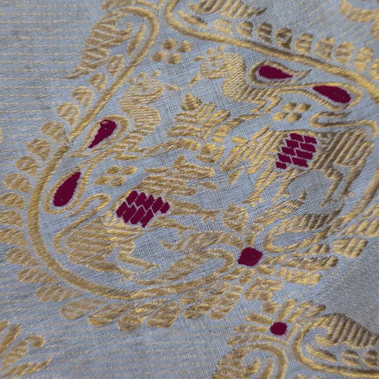 Close-up of handloom Muga silk saree showing precise Assam handloom weave with restrained border detail on naturally golden Muga silk ground, design that lets the geography speak