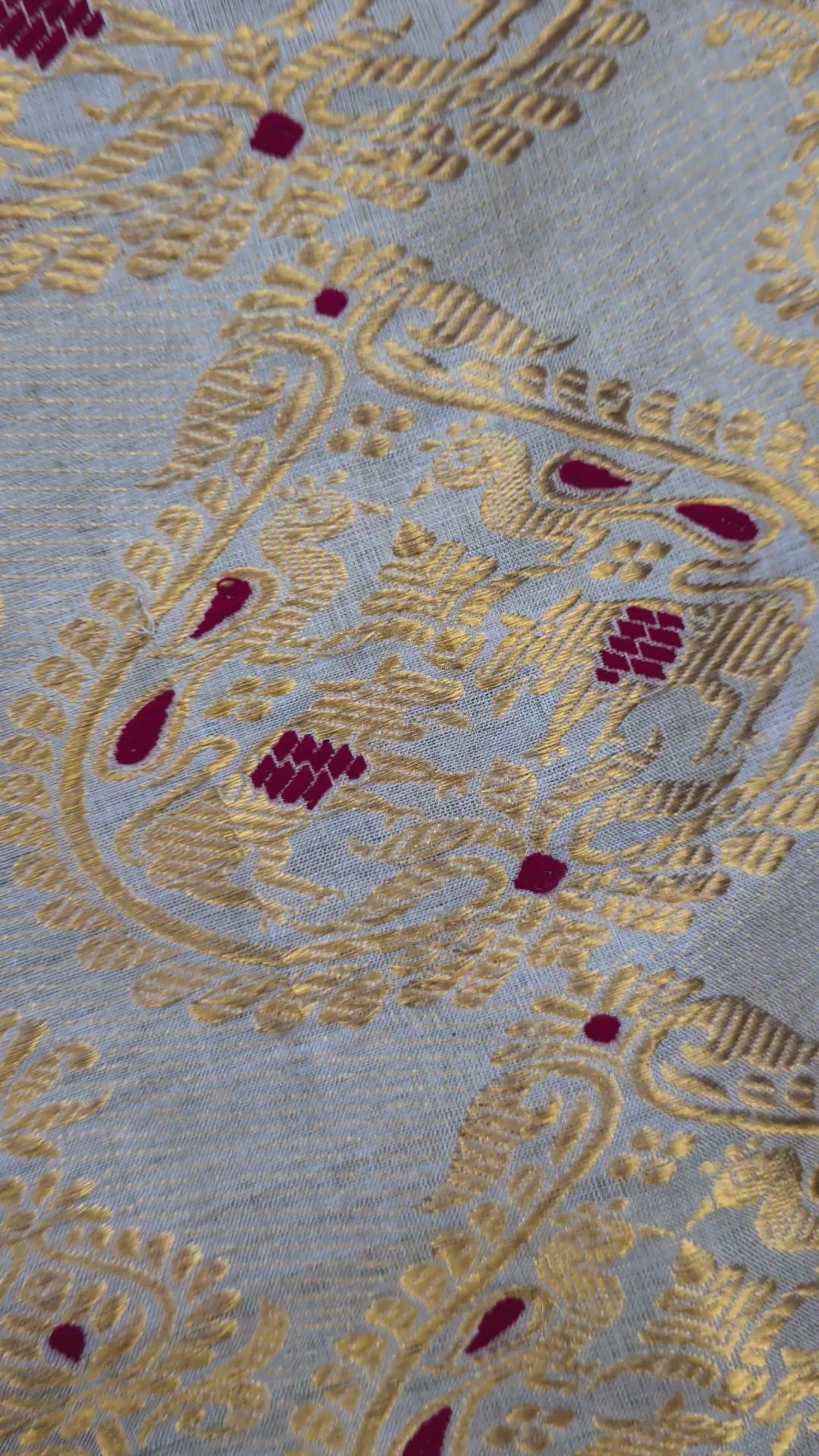Close-up of handloom Muga silk saree showing precise Assam handloom weave with restrained border detail on naturally golden Muga silk ground, design that lets the geography speak