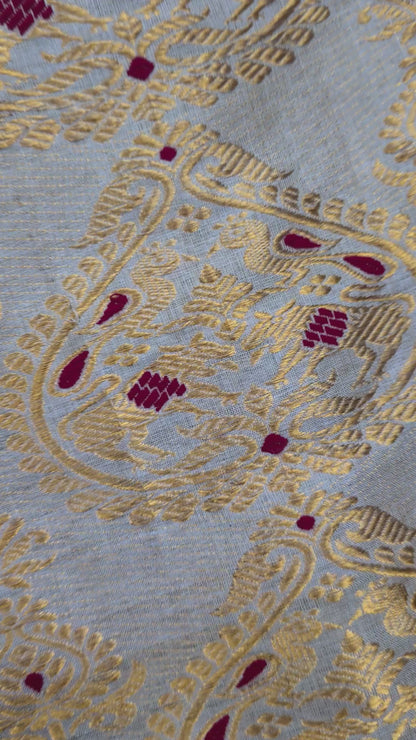Close-up of handloom Muga silk saree showing precise Assam handloom weave with restrained border detail on naturally golden Muga silk ground, design that lets the geography speak