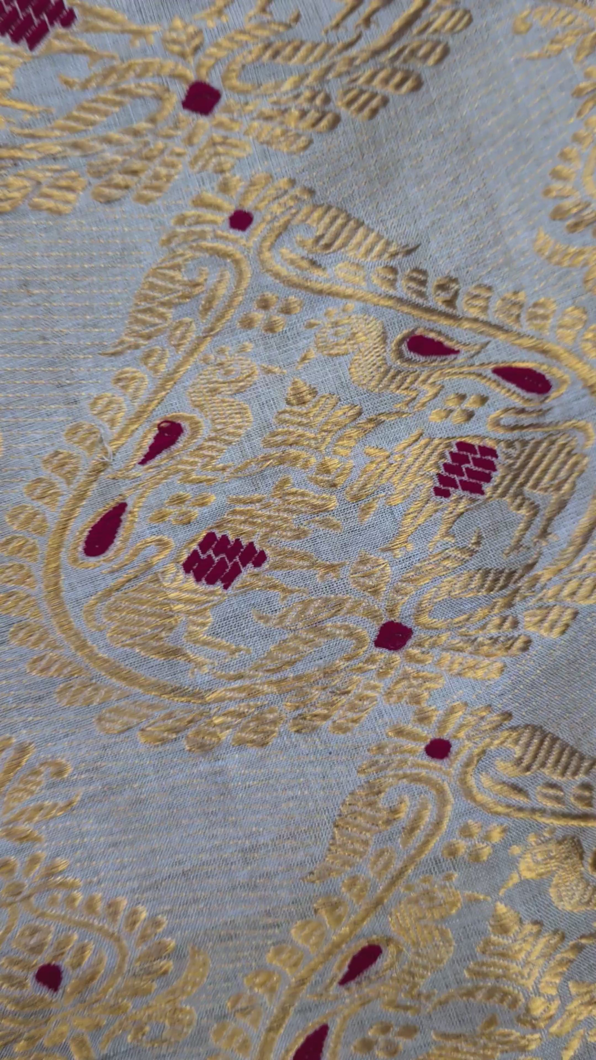 Close-up of handloom Muga silk saree showing precise Assam handloom weave with restrained border detail on naturally golden Muga silk ground, design that lets the geography speak